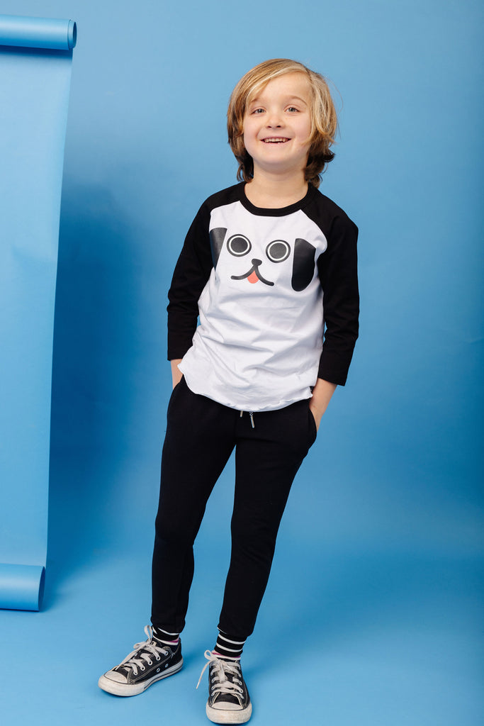 Kawaii Puppy Dog Eyes face printed in black with pink tongue on 100% organic cotton two-tone black and white baseball t-shirt. Paired with BEST bamboo joggers in black. Gender Neutral and available in kids and adult sizes. Designed in Canada.