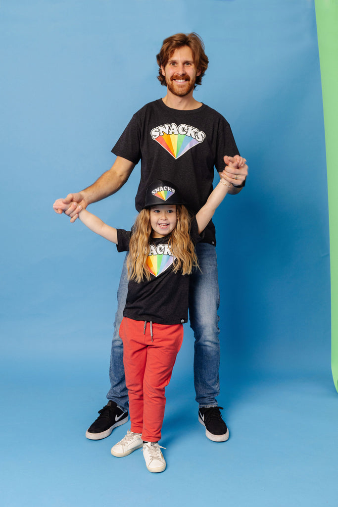 SNACKS Rainbow design printed on organic charcoal heather grey t-shirt. Paired with SNACKS Rainbow Snapback hat and BEST bamboo joggers in red. Gender Neutral and available in kids and adult sizes.