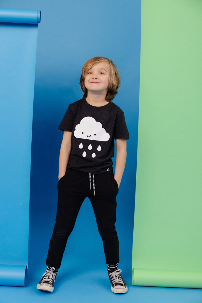 White Kawaii Raincloud design screen printed on an organic charcoal heather grey t-shirt. Available in kids and adult sizes. Paired with BEST bamboo joggers in black. Gender Neutral and ethically made. Designed in Poland.