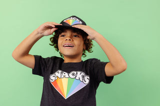 SNACKS Rainbow design screen printed in full colour onto a black flat brim snap back cap. Available in two sizes. Matching kids and adult t-shirts available.